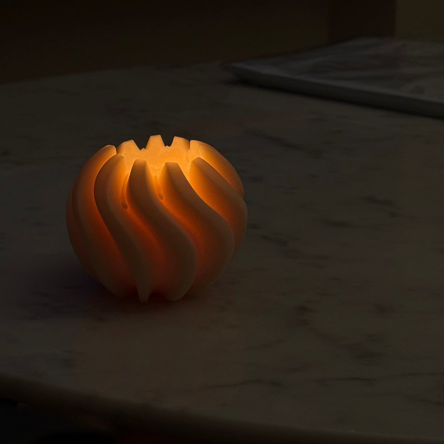 Hand-poured burning Sculptural twirl-swirl-sand dune candle in soy and beeswax blend by Quality Time Candles, inspired by naturally-formed shapes, glowing in the dark