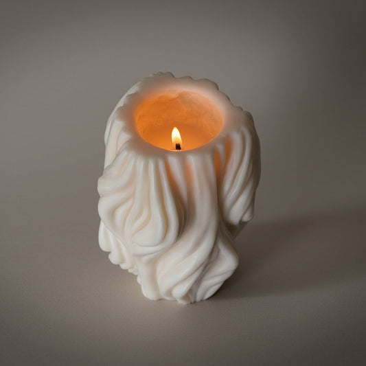 Hand-poured burning Sculptural Coastal Limestone pillar candle in soy and beeswax blend by Quality Time Candles, inspired by coastal wind-formed shapes